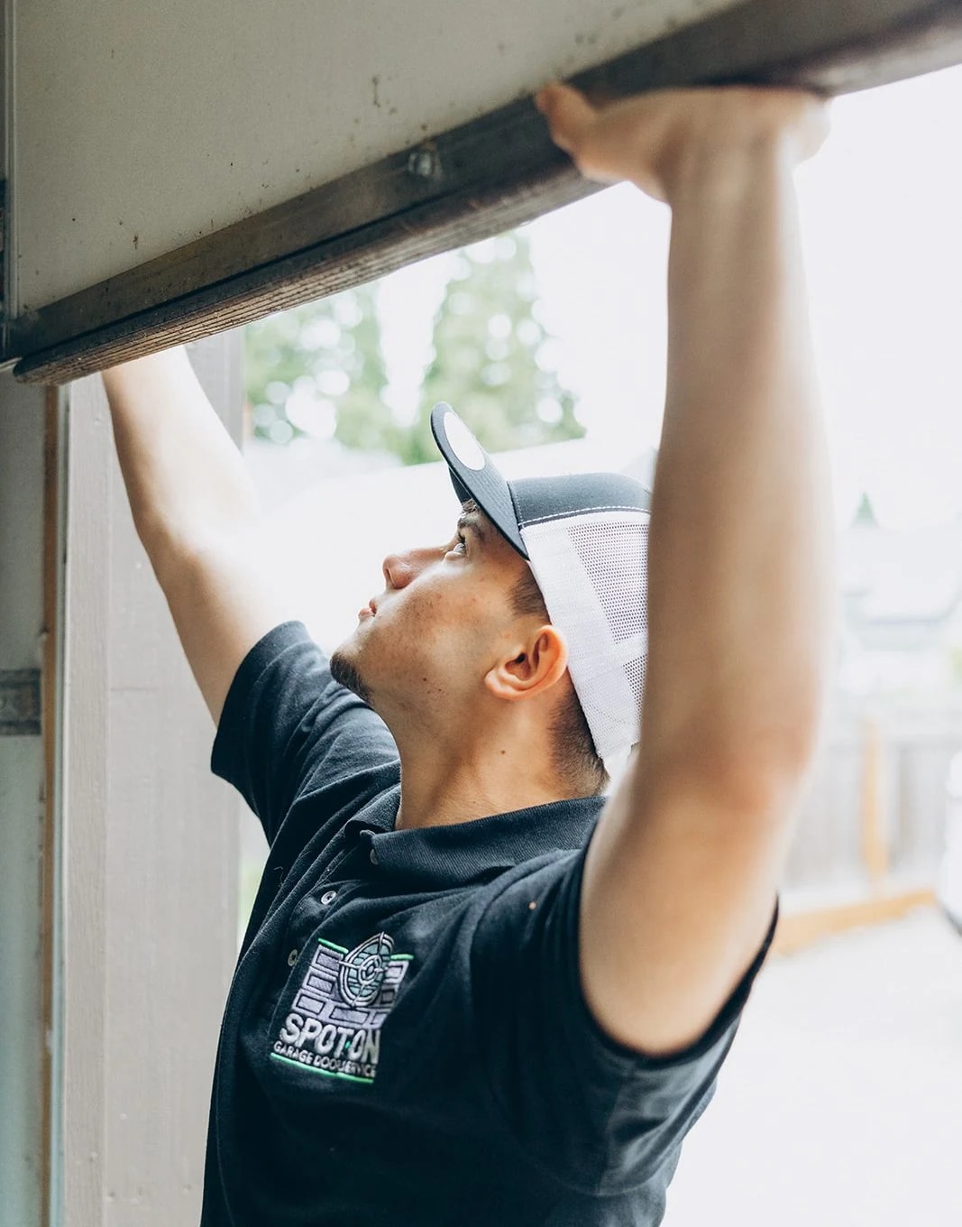 Spot On Garage Door technician inspecting a residential garage door