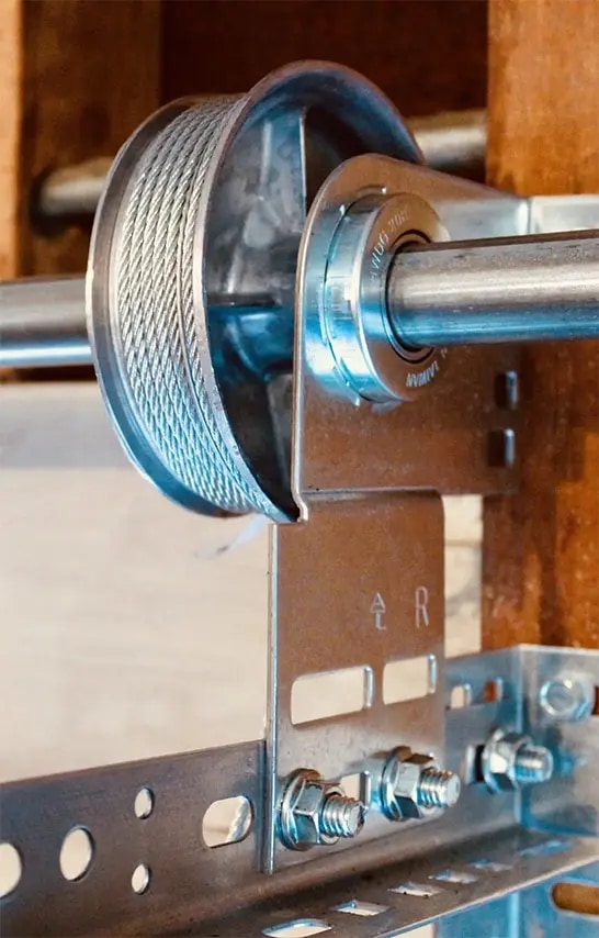 Close view of a garage door cable drum and lift cable