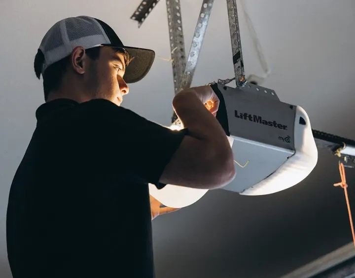 Spot On Garage Door technician servicing a residential opener