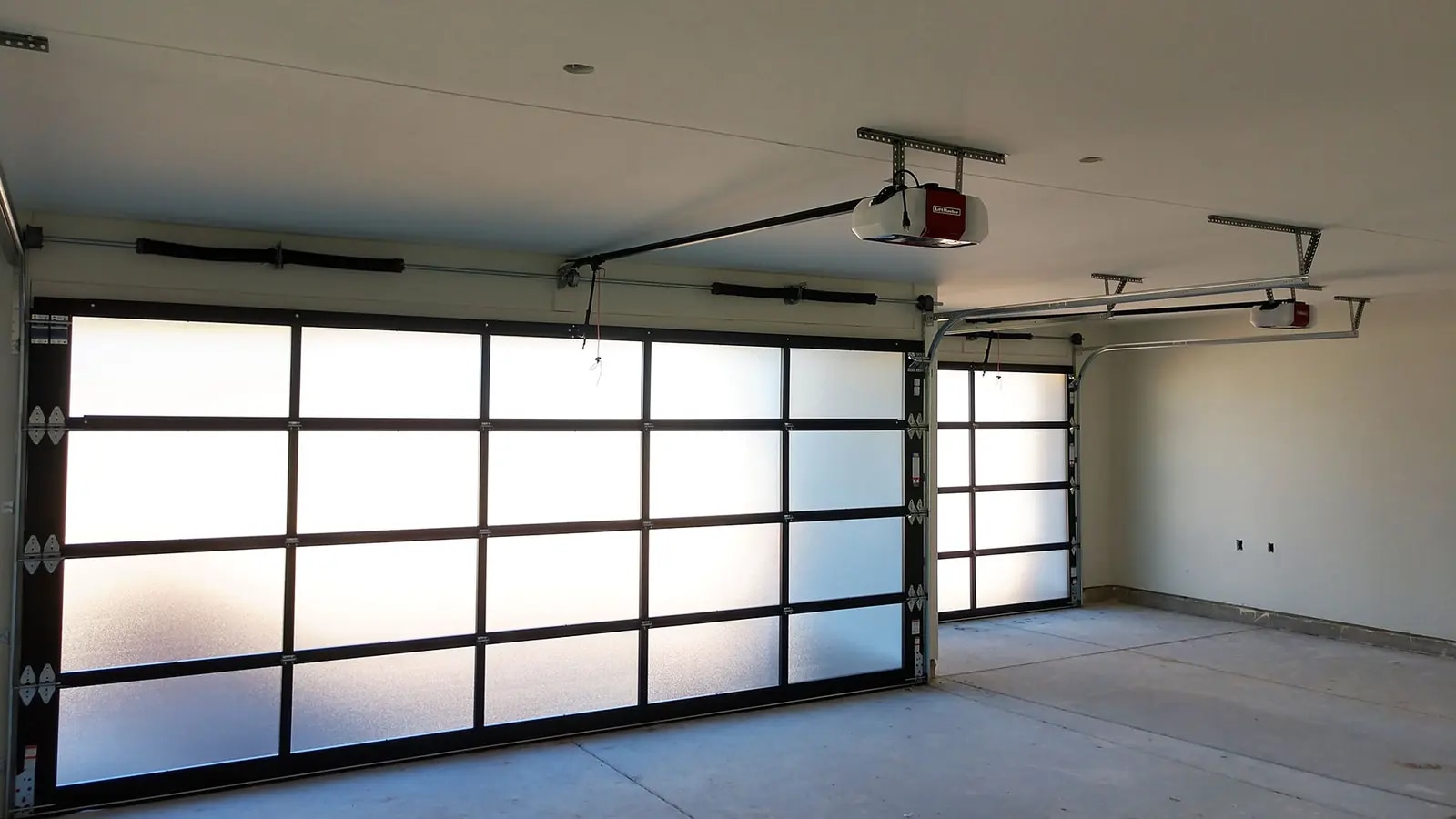 Modern residential garage doors and ceiling-mounted garage door openers