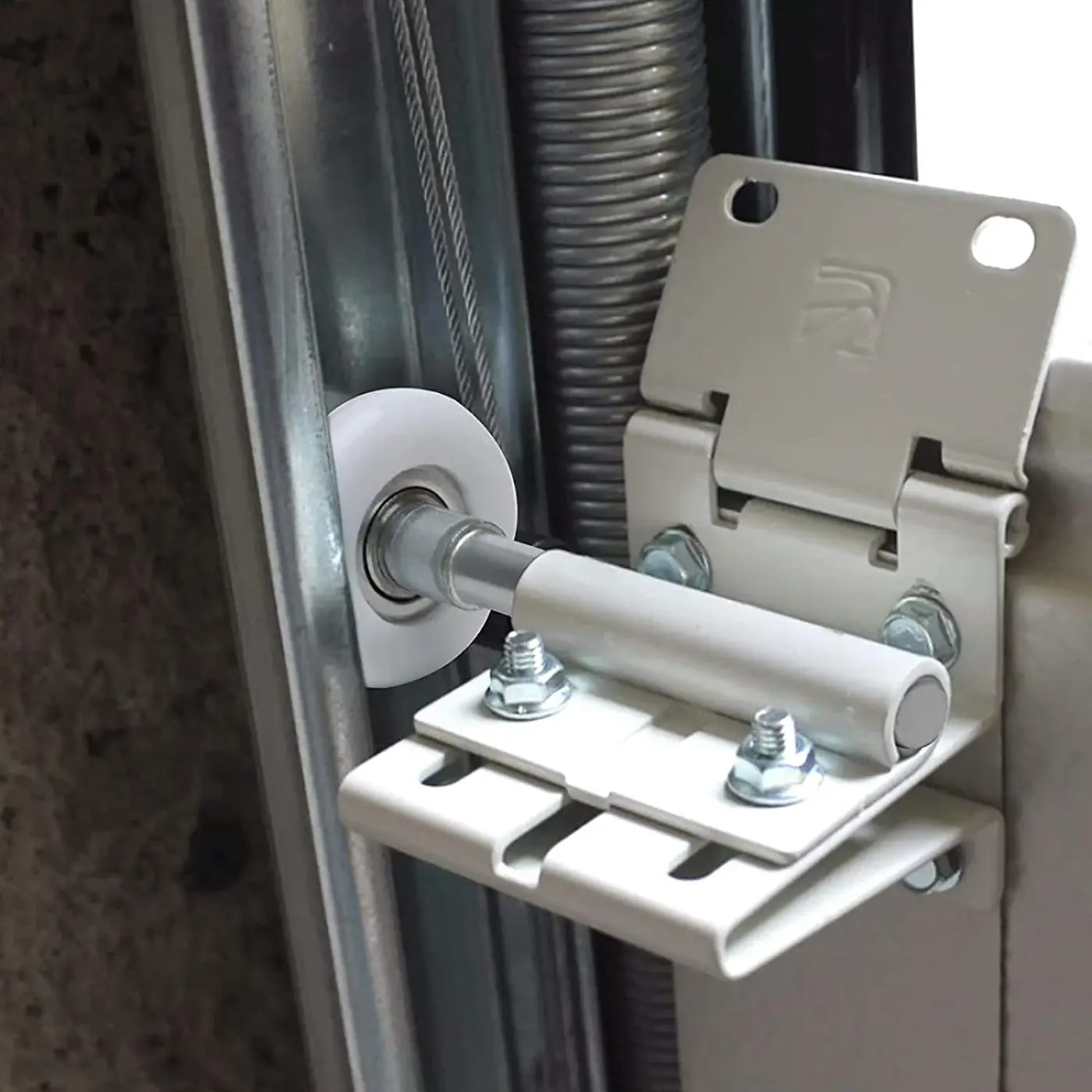 Close view of a residential garage door nylon roller, hinge, and track